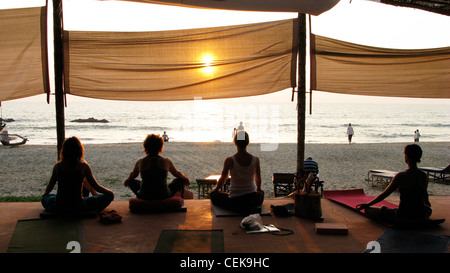 Sunset yoga and meditation on Patnem Beach, Goa (by Palolem beach), India Stock Photo