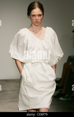 Thakoon New York Ready to Wear Spring Summer wearing a white dress with blouson sleeves gathered at the neckline Stock Photo
