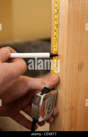 Cross recess type pan head screws in wood and being used by a builder in a house for DIY home improvements Stock Photo
