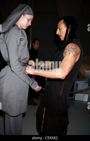 Rick Owens Backstage Paris Ready to Wear Spring Summer Model wearing a long sleeved top a gathered neckline and tie waist Stock Photo