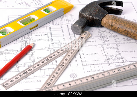 House blueprints, old hammer, pencil, level and measure Stock Photo