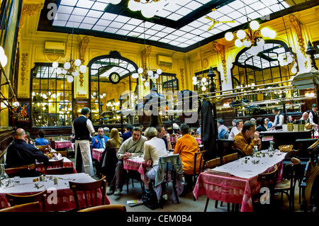 PARIS, France - People Sharing Meals inside 'Chartier' Budget French Brasserie Restaurant, Large Dining Room with Glass Ceiling, european restaurant interior, france gastronomy, Inside Paris restaurants, fine dining Paris Stock Photo
