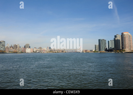 Blue sky panorama, from Circle Line Crusie, blue waters East River, north to Roosevelt Island and Queensboro Bridge, New York Stock Photo