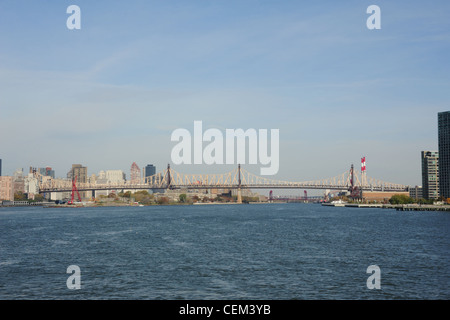 Blue sky  view, from Circle Line Cruise Boat, East Channel East River, north to Queensboro Bridge and Roosevelt Island, New York Stock Photo