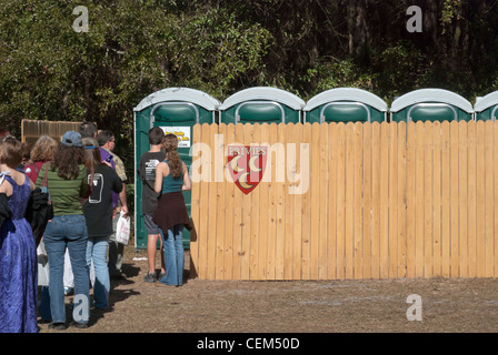 The annual Hoggetowne Medieval Faire in Gainesville Florida people waiting in line to use outhouse facilities