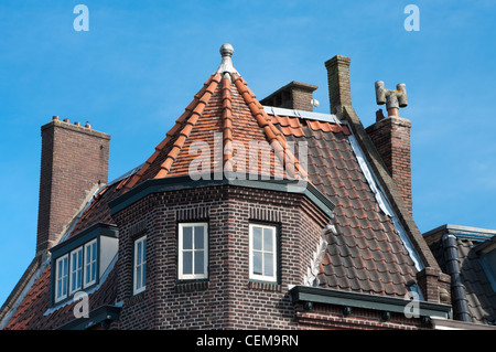 tiled roof top with several chimneys Stock Photo