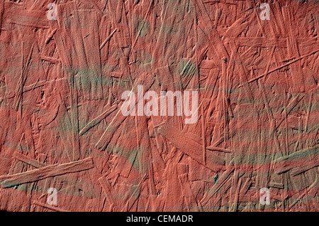 grunge old red painted chipboard closeup background Stock Photo