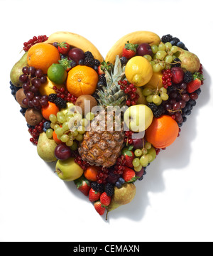 Overhead view of various types of fruit in heart shape on white background Stock Photo