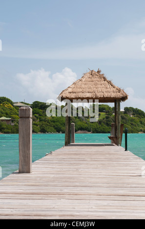 Wooden long jetty over lagoon in Maldives with amazing clean water ...