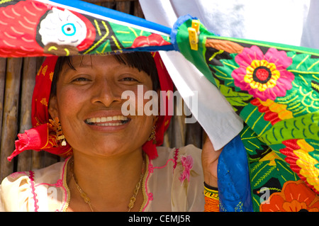 A lovely smile from a Kuna woman, taking shade behind her molas in Kuna Yala, San Blas, Panama Stock Photo