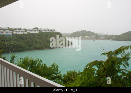 balcony view of Long Bay with resort villas and seascape in Antigua (tropical storm, rainy weather) Stock Photo