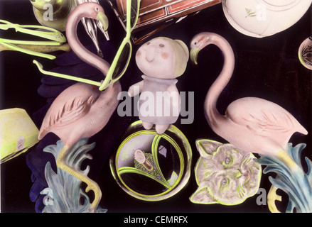Hand colored photograph of ceramic wall decor, dolls and collectibles at street fair Pink Flamingos and the Ms. Pillsburry Dough Stock Photo