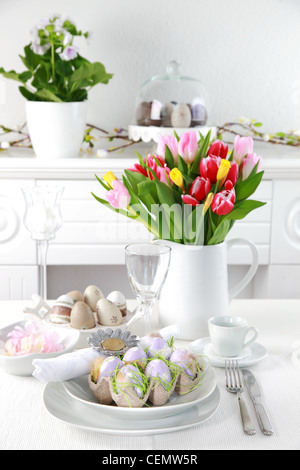 Place setting for Easter with eggs and tulips Stock Photo