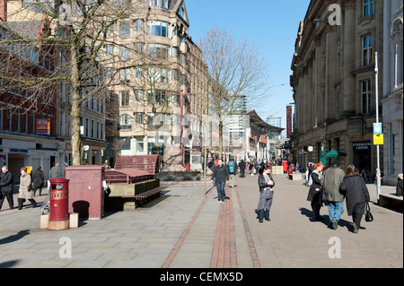 St Ann's Square in Manchester city centre busy with shoppers on a sunny clear sky day. Stock Photo