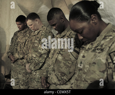 Soldiers from the 1st Air Cavalry Brigade, 1st Cavalry Division bow their heads during a Black History Month observance Feb. 18, here. The event was organized by soldiers assigned to Headquarters Support Company, 615th Aviation Support Battalion, 1st ACB, and emphasized the contributions of black American inventors. Stock Photo
