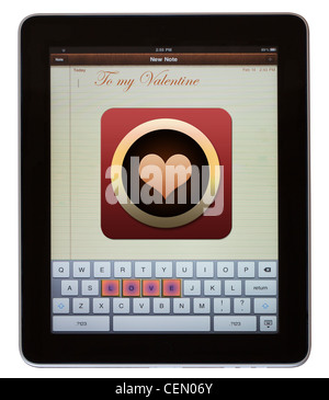 LOVE spelled out on keypad of pad computer with heart icon Stock Photo