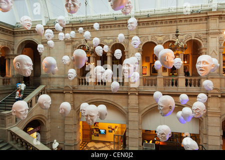 Heads on display from the ceiling of the Kelvingrove Art Gallery and Museum in Glasgow. The exhibit is Expression by Sophie Cave Stock Photo