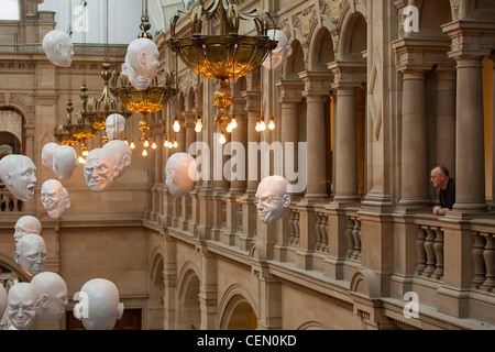 Heads on display from the ceiling of the Kelvingrove Art Gallery and Museum in Glasgow. The exhibit is Expression by Sophie Cave Stock Photo