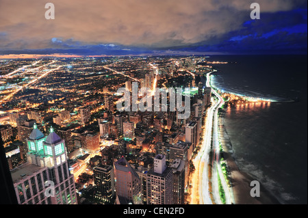 Chicago skyline panorama aerial view with skyscrapers over Lake Michigan with cloudy sky at dusk. Stock Photo