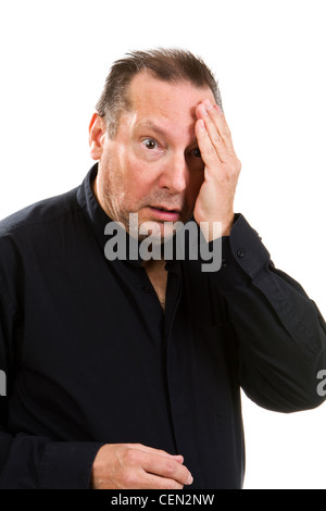 Man suffering from a headache holds his hand to his head in pain. Stock Photo