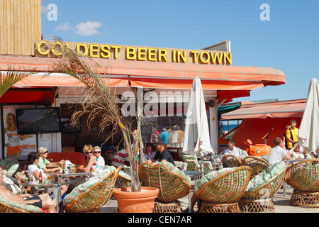 Tourists enjoying sun in beach bar at Playa del Ingles, Gran Canaria, Canary Islands, Spain Stock Photo