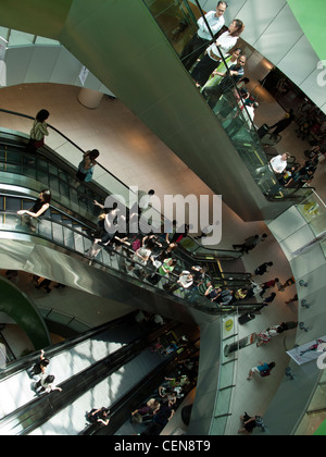 Shoppers ride the escalators in VivoCity shopping mall in Singapore. Stock Photo