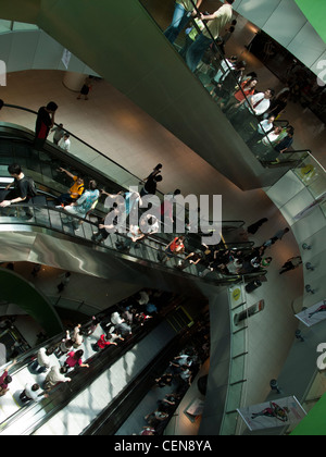 Shoppers ride the escalators in VivoCity shopping mall in Singapore. Stock Photo