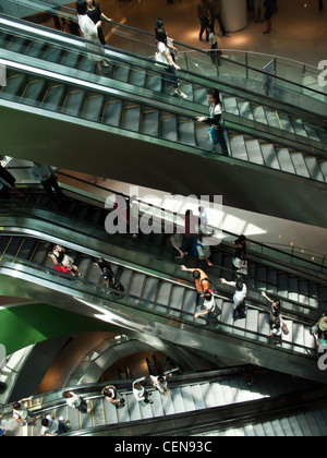 Shoppers ride the escalators in VivoCity shopping mall in Singapore. Stock Photo