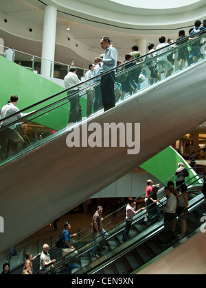 Shoppers ride the escalators in VivoCity shopping mall in Singapore. Stock Photo