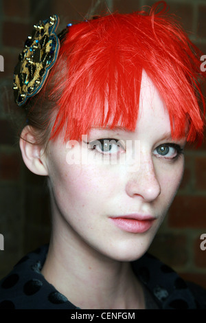 Luella Backstage London Ready to Wear Autumn Winter Punk Look: Head shot of female with fringed brightly coloured red hair Stock Photo