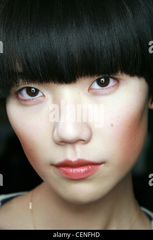 Peter Jensen Backstage London Ready to Wear Autumn Winter Close up face of female dark long fringe, wearing bronze blusher and Stock Photo