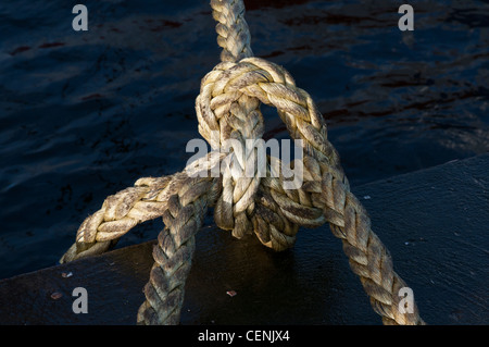 Close up of trawlers rope tied at harbour Stock Photo