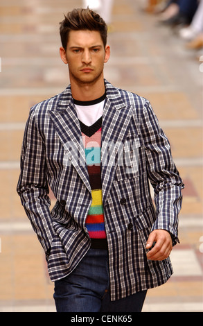 Sonia Rykiel Paris Menswear S S Male model wearing black and white checked jacket over multicoloured striped tank top Stock Photo