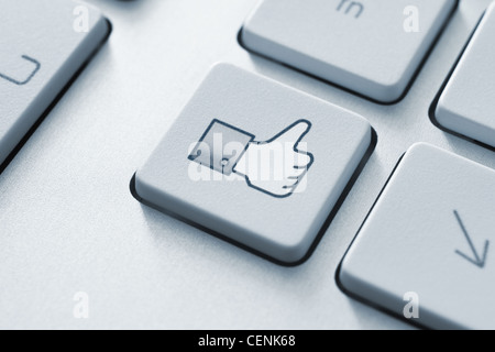 Thumb up like button on the keyboard. Toned Image. Stock Photo