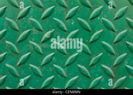 Diamond metal painted green on piece of background Stock Photo
