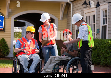 Project engineers discussing data at new building site architects Stock Photo
