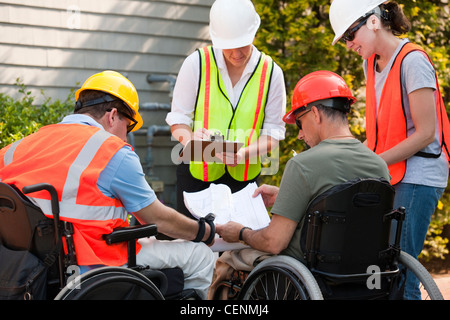 Project engineers discussing data at new building site Stock Photo