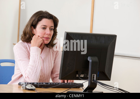 Engineering student studying computer display in a classroom Stock Photo