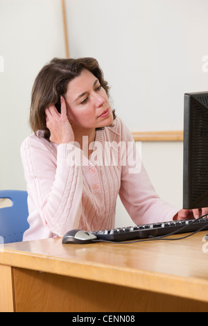 Engineering student studying computer display in a classroom Stock Photo