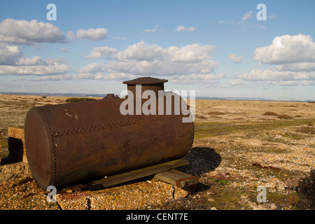 abandoned rusty steam boiler on beach in Dungeness in kent Stock Photo