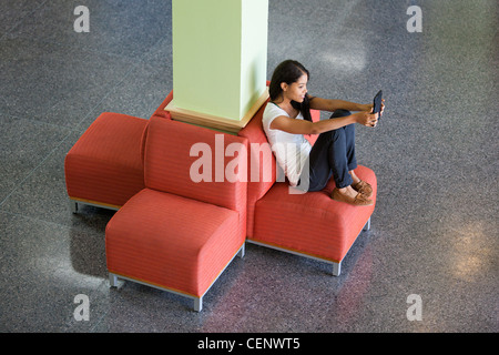 Engineering student reading a digital tablet in student lounge Stock Photo