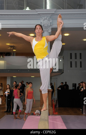 Stella McCartney Adidas London Ready to Wear Spring Summer Female on gymnastics balance beam, one leg up Stock Photo