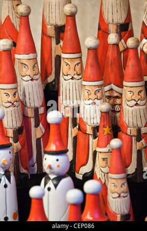 Wooden Santa Claus Christmas decorative ornaments on sale at a German Christmas Market in Leeds, West Yorkshire, UK Stock Photo