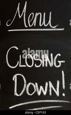 CLOSING DOWN writhed on Restaurant / Cafe Blackboard. Recession Credit Crunch Concept Stock Photo