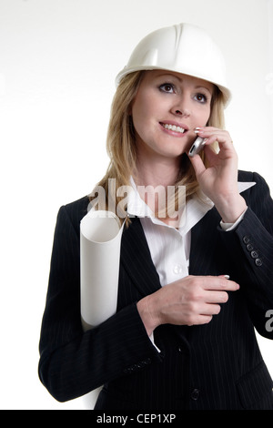 Architect on the phone holding blueprints Stock Photo