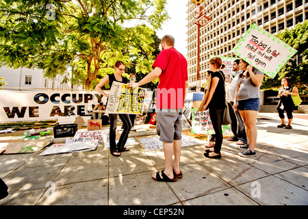 Protesters show new signs expressing the We-Are-the-99% anti-capitalism sentiments of Occupy Wall Street presence in Los Angeles Stock Photo