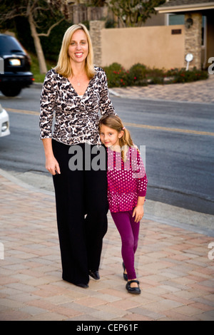 A 29 year old mother and her 6 year old daughter on their suburban street in San Juan Capistrano, CA. MODEL RELEASE