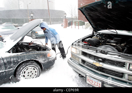 Woman Having Car Trouble in Snowstorm Boston Stock Photo