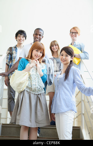 University students standing on stairs Stock Photo