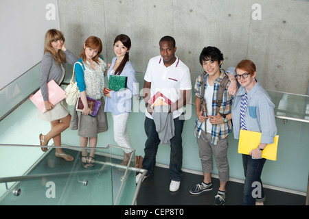 University students standing on stairs Stock Photo